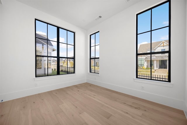 unfurnished room with light wood-type flooring