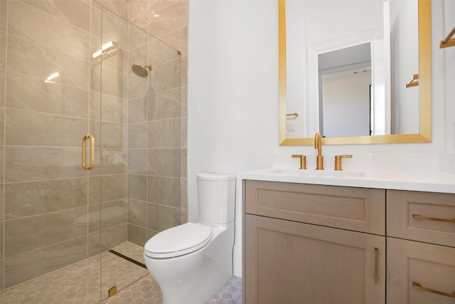 bathroom with vanity, a shower with door, and toilet