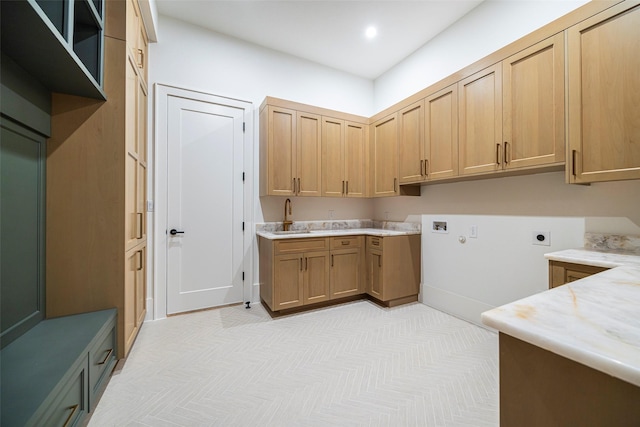 laundry area with sink, cabinets, and hookup for an electric dryer