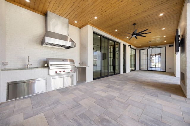 view of patio with area for grilling, sink, and ceiling fan