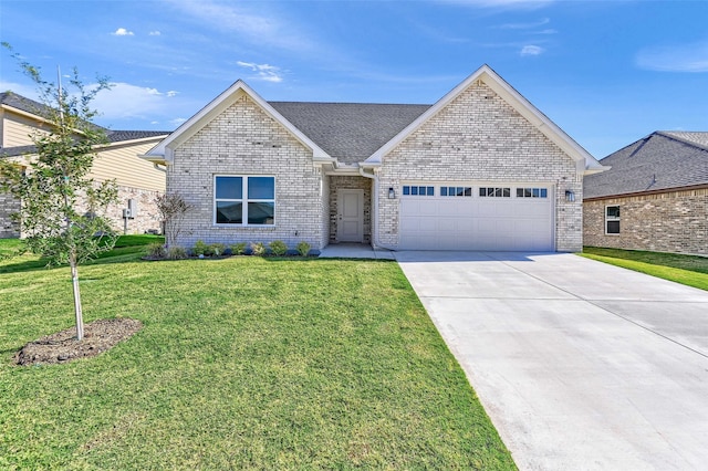 view of front of house featuring a front yard and a garage