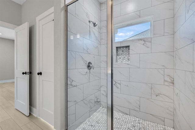 bathroom featuring tile patterned floors and an enclosed shower