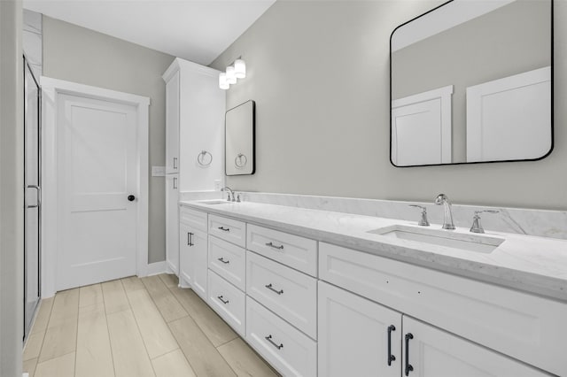 bathroom with hardwood / wood-style floors and vanity