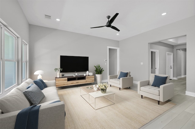 living room featuring light wood-type flooring and ceiling fan