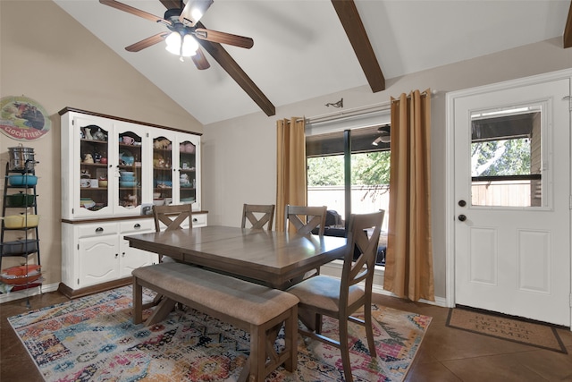 dining room with beamed ceiling, ceiling fan, dark tile patterned floors, and a wealth of natural light