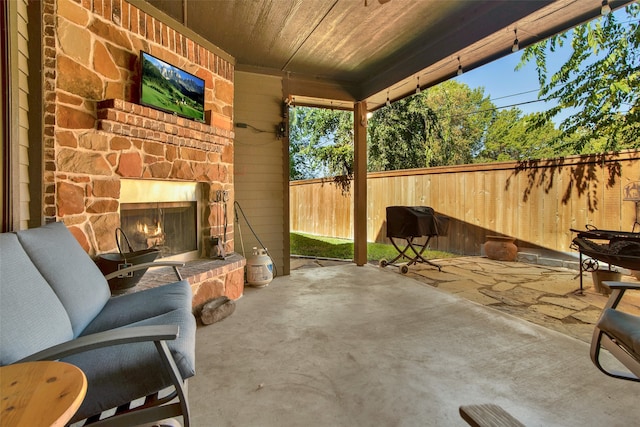 view of patio with an outdoor stone fireplace