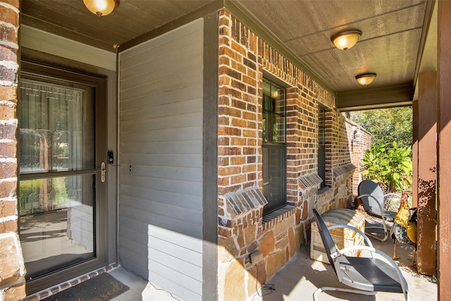 view of exterior entry featuring a porch