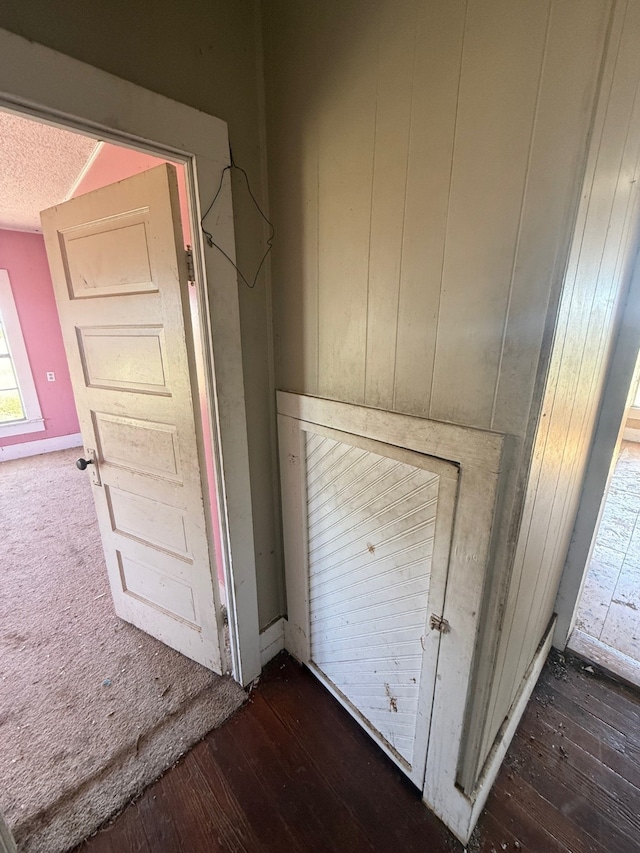 room details featuring wooden walls and hardwood / wood-style floors