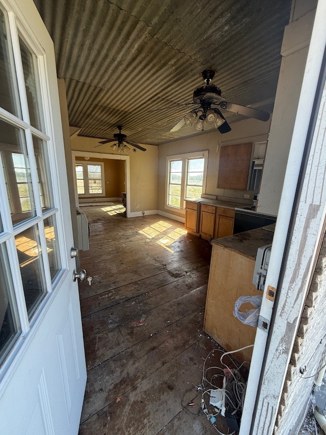 interior space with dark wood-type flooring and ceiling fan