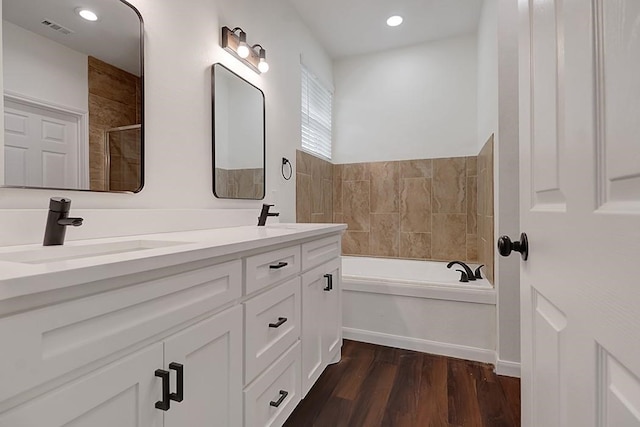 bathroom featuring vanity, independent shower and bath, and hardwood / wood-style flooring