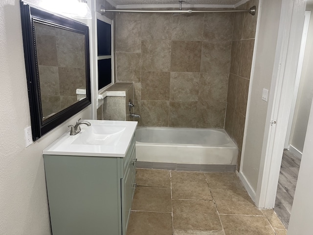 bathroom featuring vanity and tiled shower / bath combo