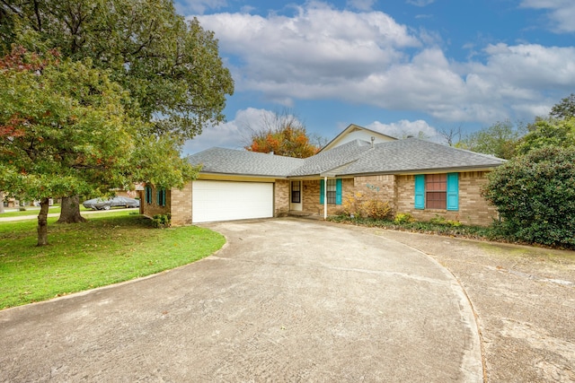 ranch-style home with a front yard and a garage