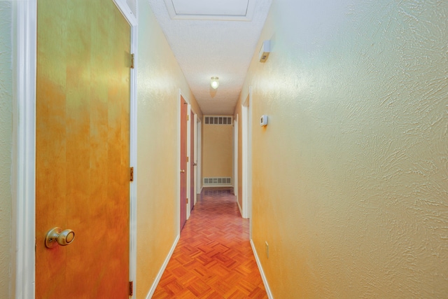 corridor featuring a textured ceiling