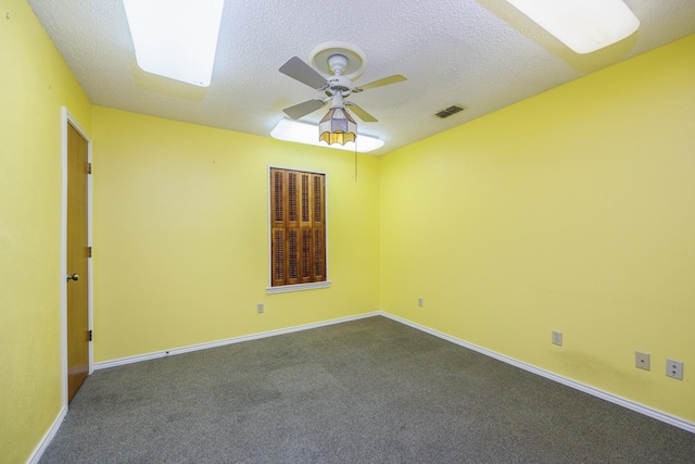 406 Rita Ln, Duncanville, TX 75116 - spare room with a ceiling fan, a textured ceiling, and dark carpet