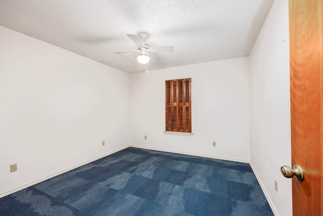 carpeted empty room with a textured ceiling and ceiling fan