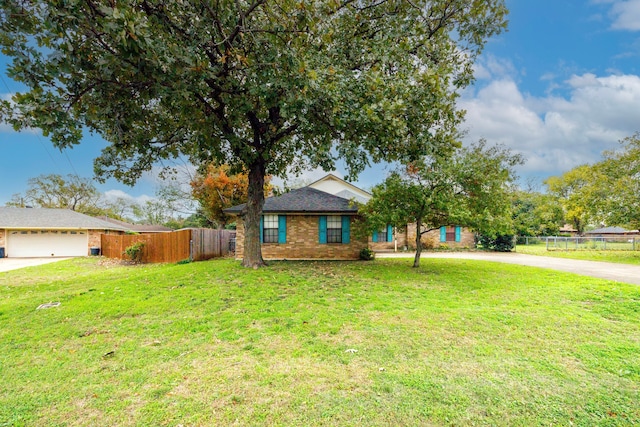 ranch-style house with a front yard and a garage