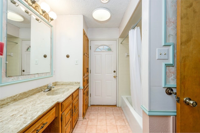 bathroom with shower / tub combo with curtain, vanity, a textured ceiling, and tile patterned flooring