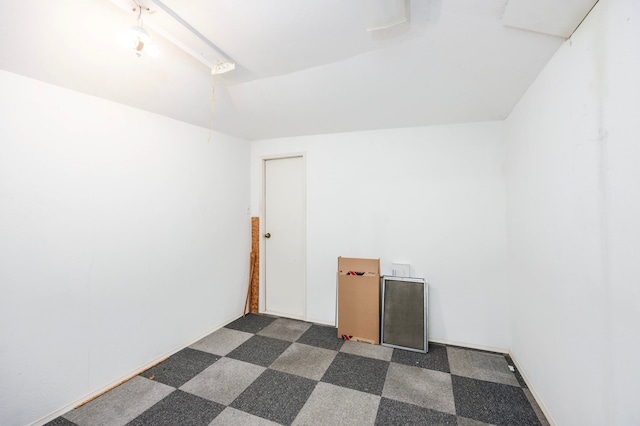 empty room with dark colored carpet