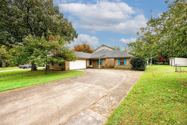 ranch-style home featuring a front lawn and a garage