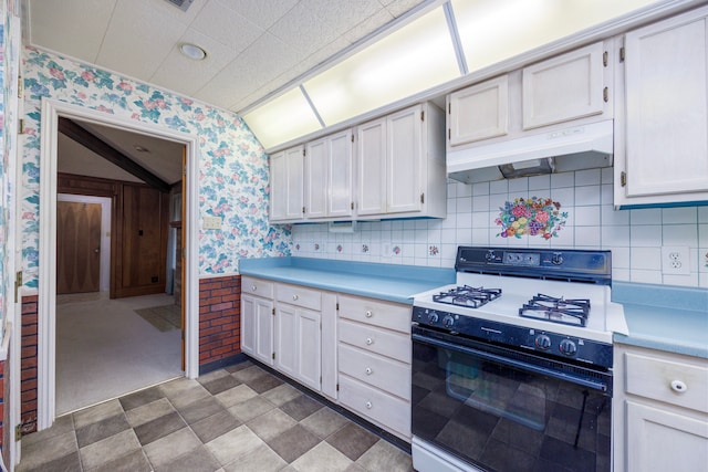 kitchen with white cabinets, wooden walls, carpet, and white range oven