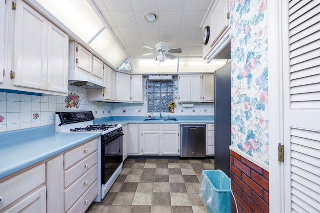 kitchen featuring backsplash, sink, white cabinetry, appliances with stainless steel finishes, and ceiling fan