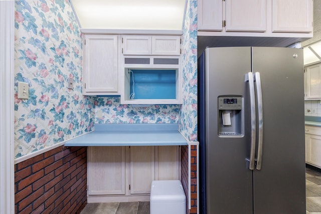 406 Rita Ln, Duncanville, TX 75116 - kitchen featuring stainless steel fridge with ice dispenser, wallpapered walls, tile patterned flooring, and light countertops