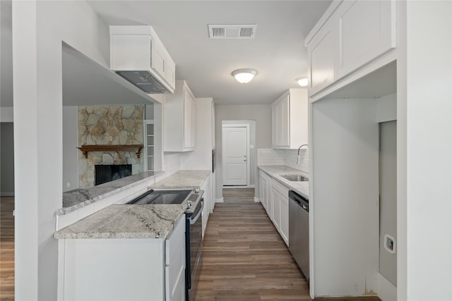 kitchen featuring white cabinetry, light stone countertops, appliances with stainless steel finishes, and sink