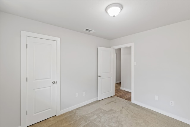 unfurnished bedroom with light carpet