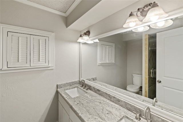 bathroom featuring a textured ceiling, an enclosed shower, toilet, vanity, and ornamental molding