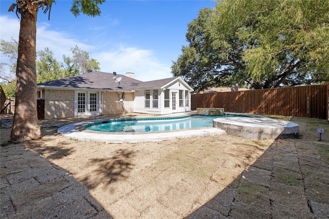 view of swimming pool featuring an in ground hot tub and a patio