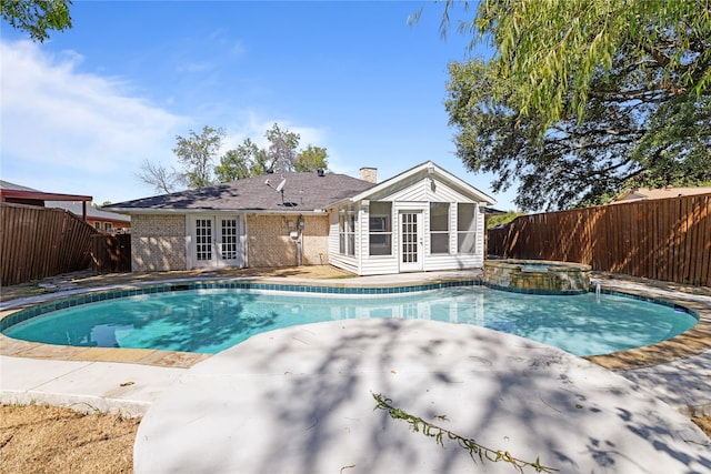 view of swimming pool featuring french doors