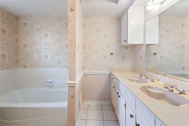 bathroom with vanity, a tub, and tile patterned flooring