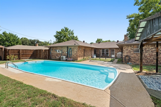 view of pool with a patio and a diving board