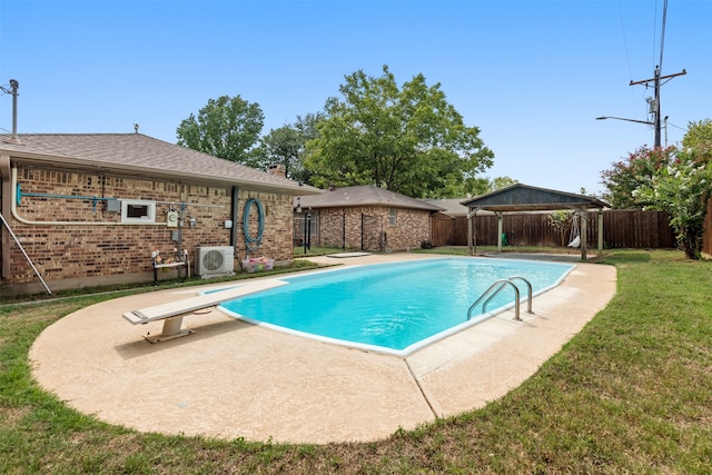 view of pool featuring a yard, a patio, a diving board, and ac unit