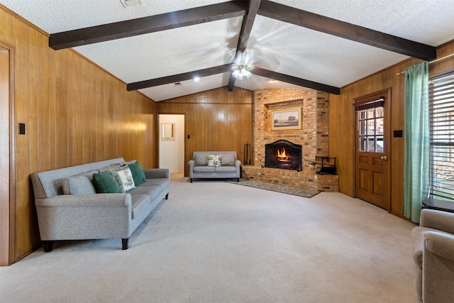 living room featuring ceiling fan, a textured ceiling, a brick fireplace, carpet floors, and wooden walls