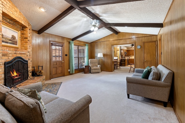 living room with light carpet, wood walls, a textured ceiling, and a brick fireplace