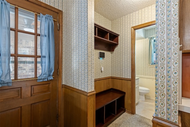 mudroom with a textured ceiling