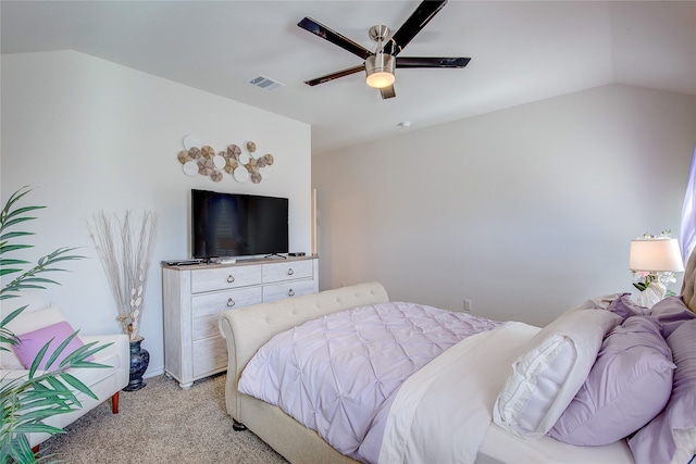 bedroom featuring ceiling fan, vaulted ceiling, and light colored carpet