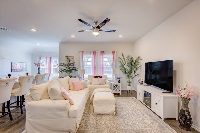 living room with dark hardwood / wood-style floors and ceiling fan