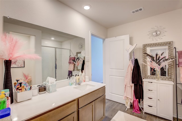 bathroom with vanity, hardwood / wood-style floors, and walk in shower