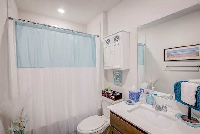 bathroom featuring vanity, toilet, and a shower with shower curtain