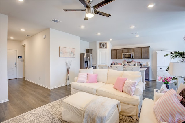 living room with dark wood-type flooring and ceiling fan