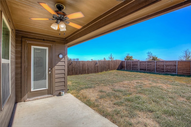 view of yard with a patio area and ceiling fan