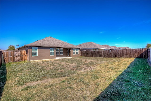 rear view of house with a yard