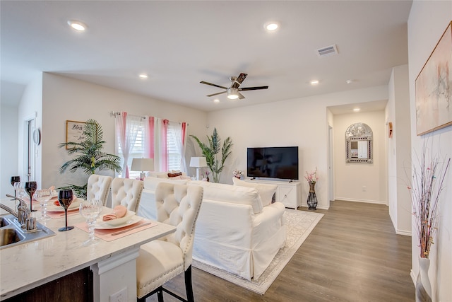 living room with dark wood-type flooring and ceiling fan