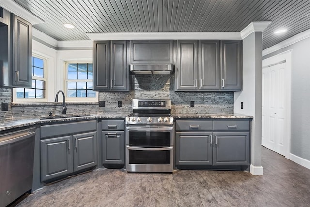 kitchen with gray cabinets, dark stone countertops, stainless steel appliances, and exhaust hood