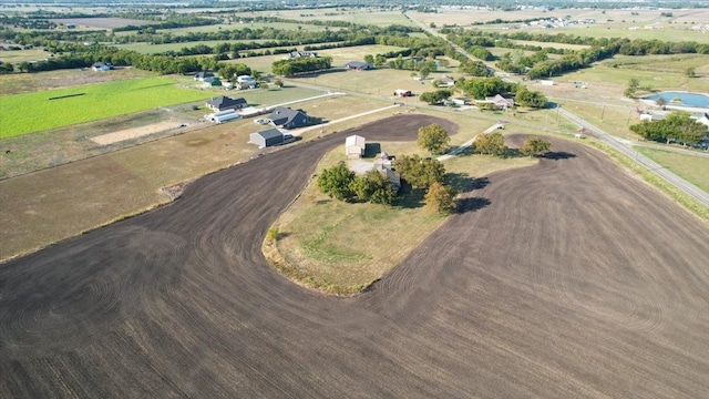 birds eye view of property with a rural view