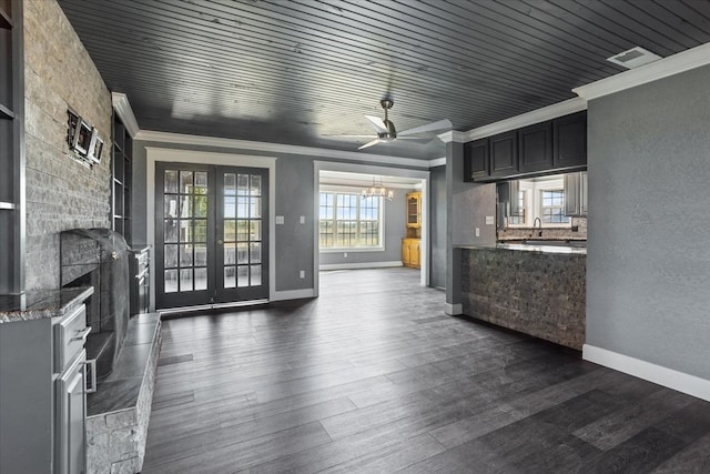 unfurnished living room featuring crown molding, wooden ceiling, dark wood-type flooring, and ceiling fan with notable chandelier