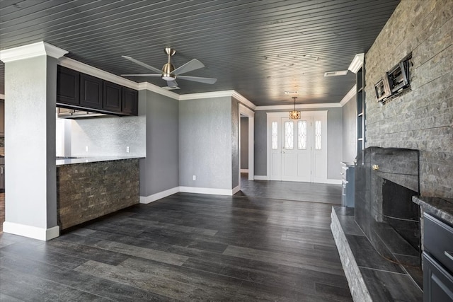 unfurnished living room featuring ornamental molding, ceiling fan with notable chandelier, wooden ceiling, and dark hardwood / wood-style flooring