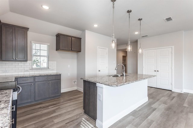 113 Bailey Ranch Dr, Lindsay, TX 76240 - kitchen featuring a sink, light wood-type flooring, baseboards, light stone countertops, and recessed lighting